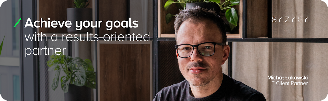Michal Lukawski, IT Client Partner, against the background of a modern office with plants and wooden shelves. Text on the graphic: 'Realize your goals with a partner that focuses on results.' SYZYGY logo in the upper right corner. The graphic promotes collaboration with an IT partner focused on achieving business goals - Include metrics in the goal formula , which will establish the minimum acceptable levels of a given criterion or the level desired to be achieved.